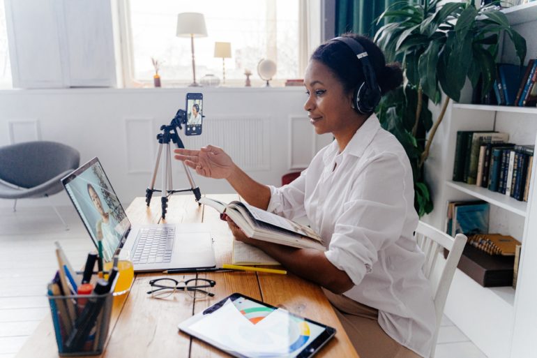 Woman on a virtual meeting in her home office, she is being recorded